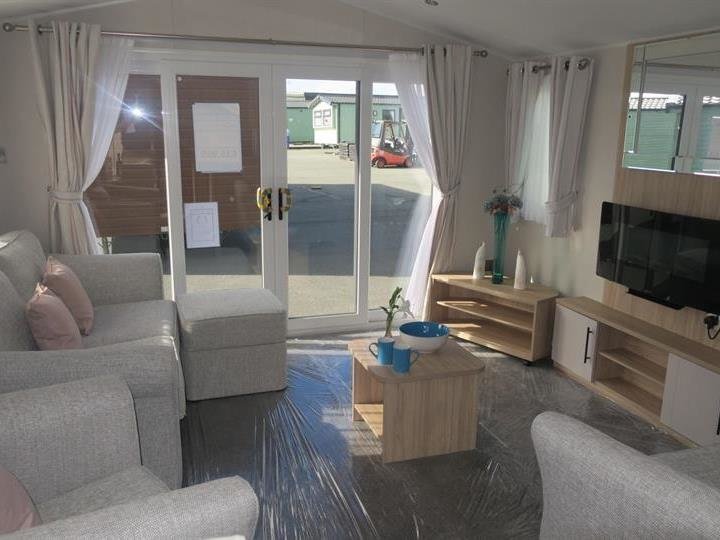 holiday parks wales home for sale with electric fireplace and grey furniture