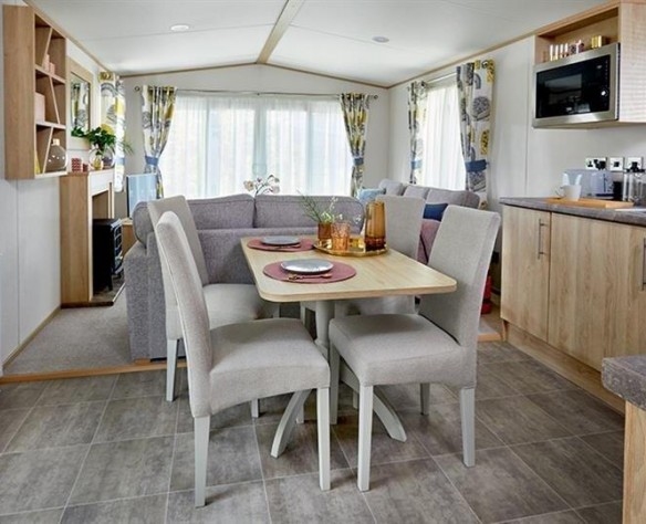 luxury holiday parks uk with a high quality 4 seat dining table leading to well furnished living room