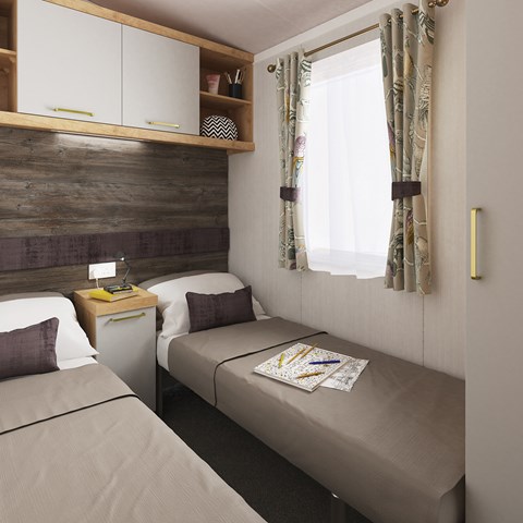 bedroom of caravans for sale north wales featuring two single beds and overhead storage space